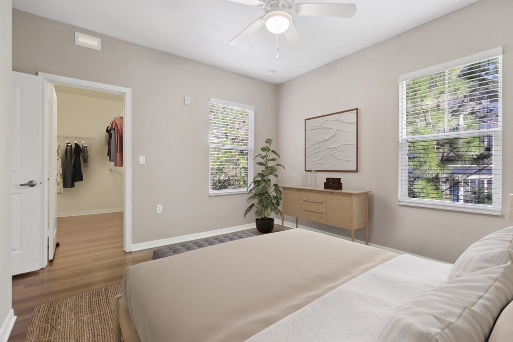 Bedroom with a ceiling fan and large closet at The Amalfi Clearwater Apartments