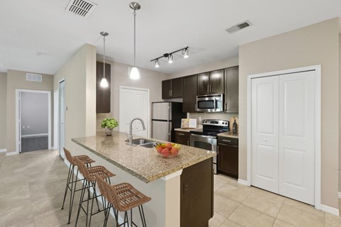 a kitchen with a marble counter top with bar stools