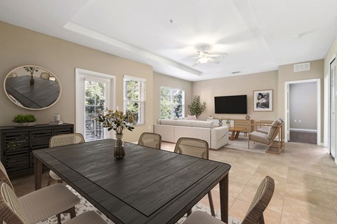 a dining room and living room with a table and chairs