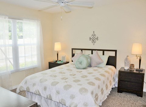 a bedroom with a bed and a ceiling fan