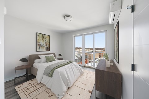 A bedroom with a large bed and a view of the outside.