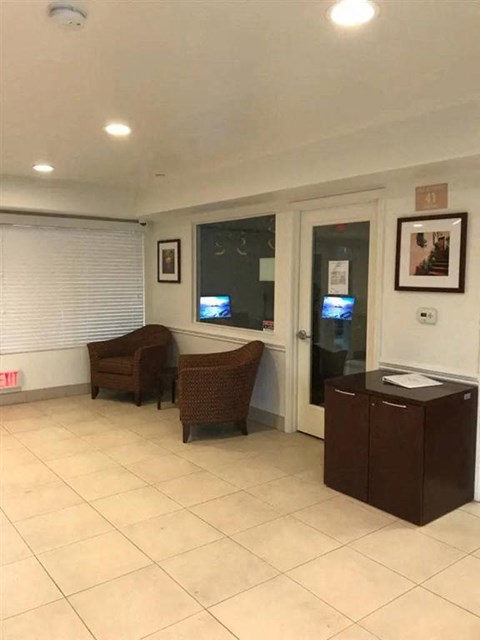a living room with two chairs and a glass door