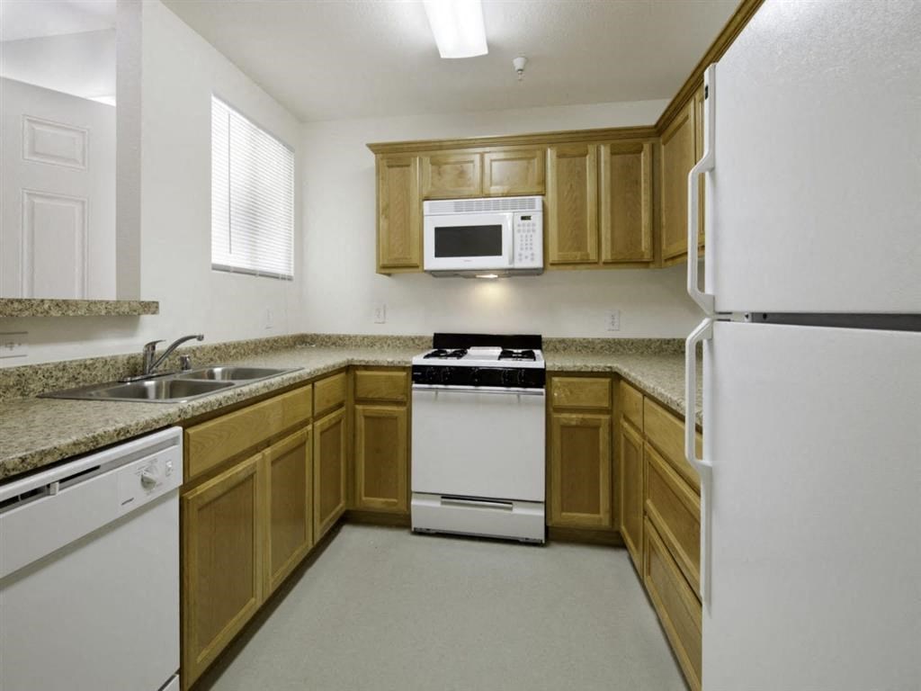 a kitchen with a stove microwave and a sink
