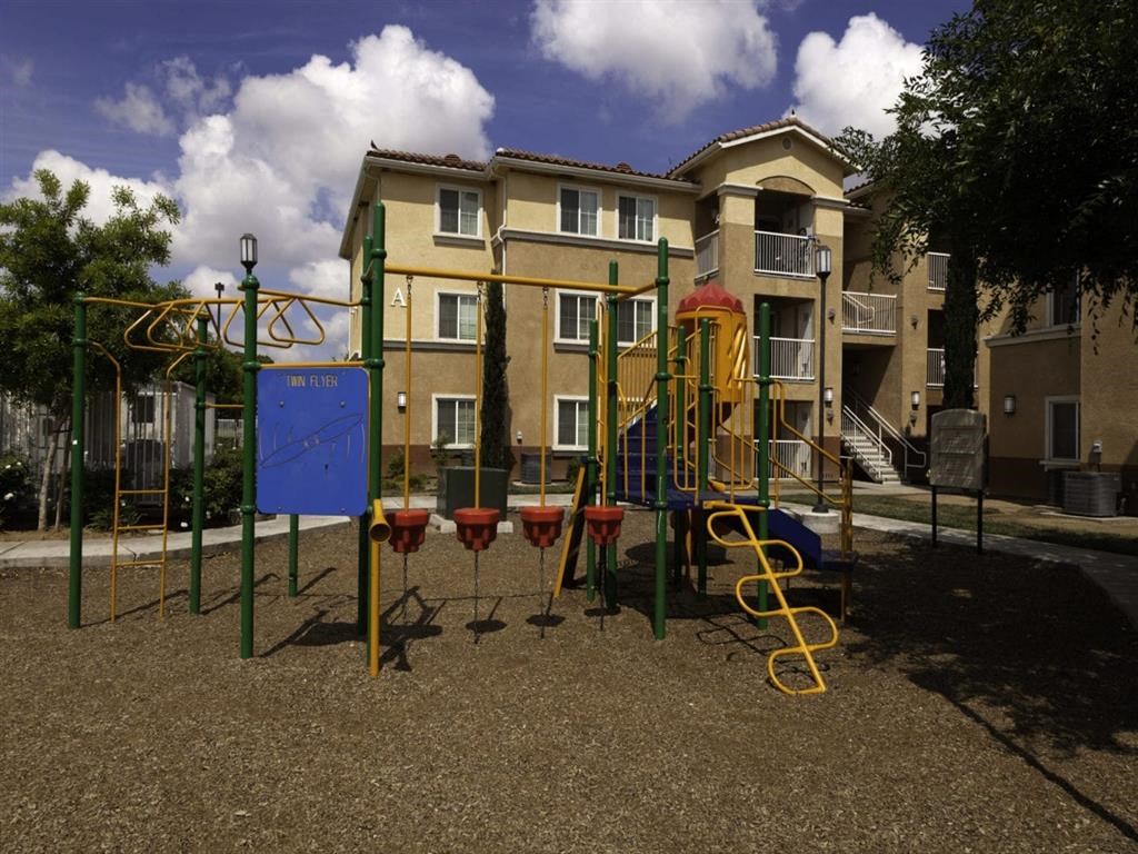 a playground in front of an apartment building