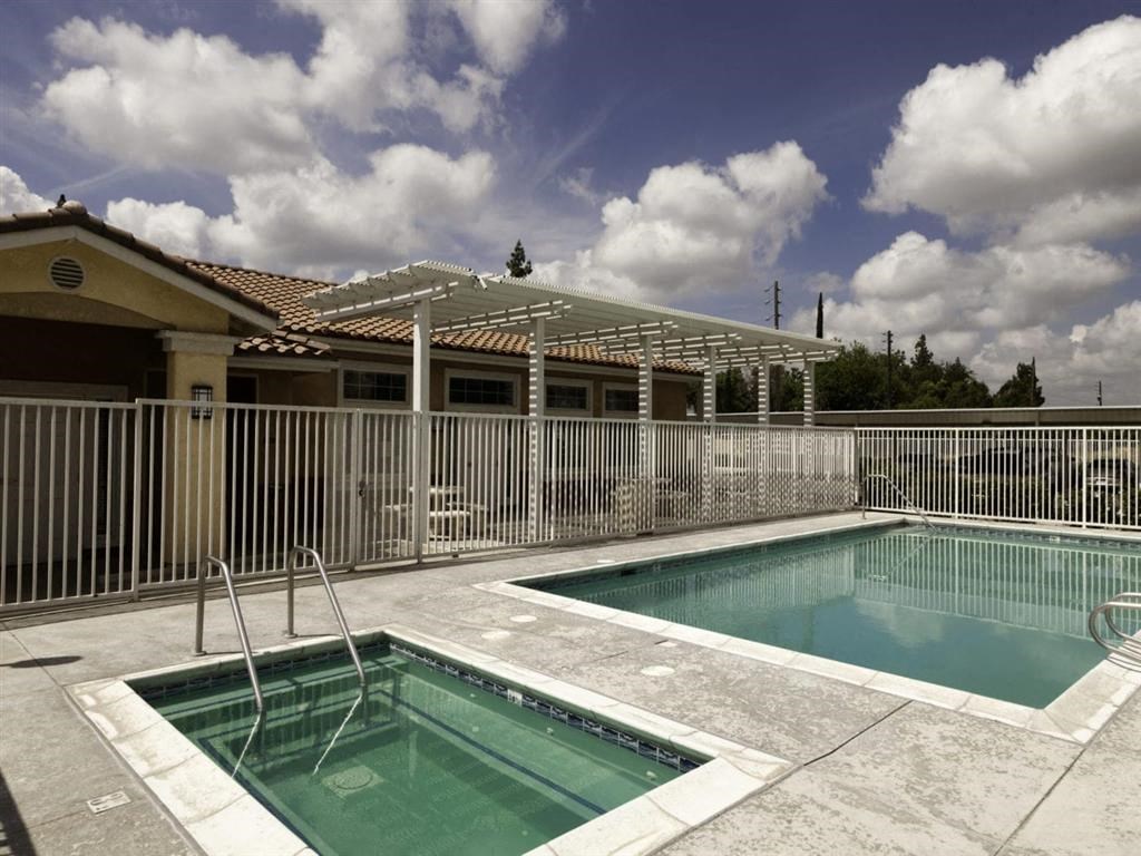 a swimming pool and a house with a roof