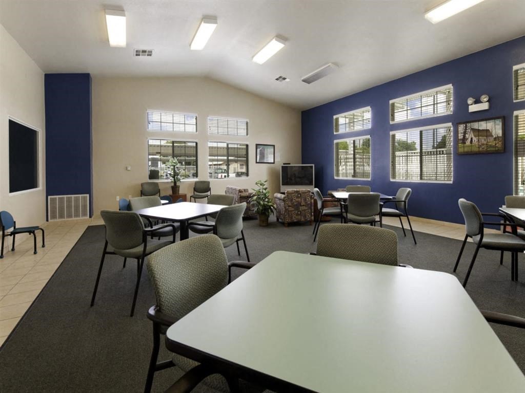 a dining room with tables and chairs and a television