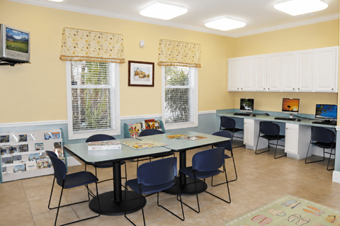 A dining room with a table and chairs.