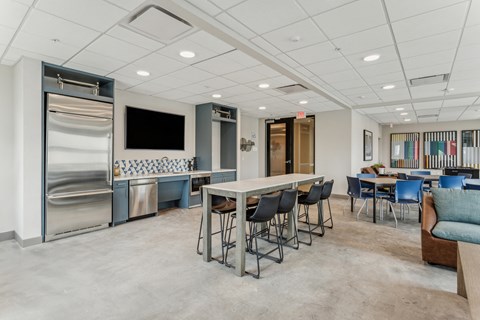 A spacious room with a bar area and seating.