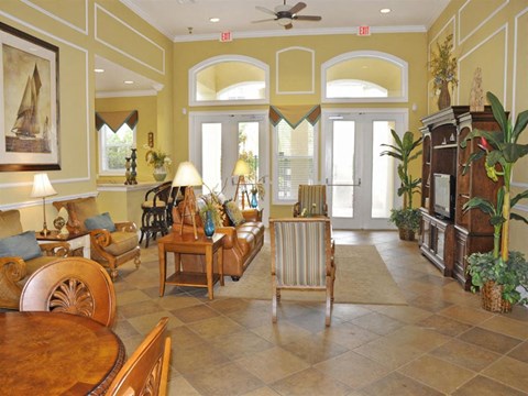 a living room filled with furniture and a ceiling fan