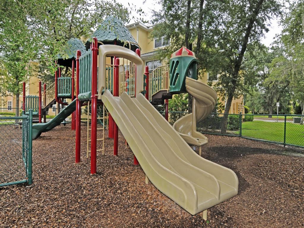 a playground with a slide in a park