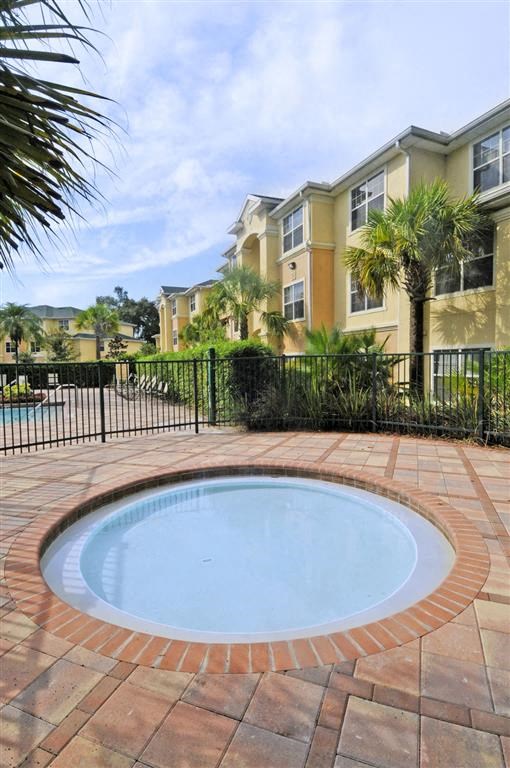 a small swimming pool in front of an apartment building