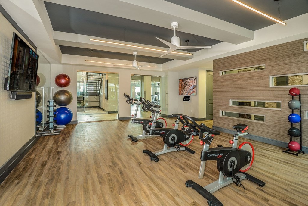 a gym with weights and cardio equipment on a wooden floor  at Grady Square, Tampa, 33607