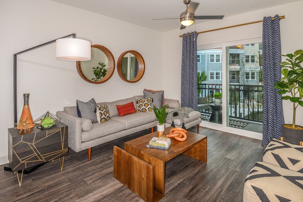 a living room with a couch and a coffee table and a balcony  at Grady Square, Tampa