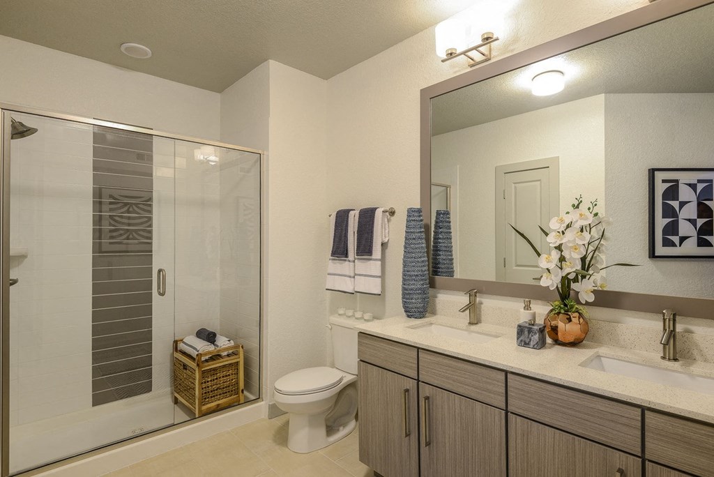 a bathroom with a shower and a sink and a mirror  at Grady Square, Florida
