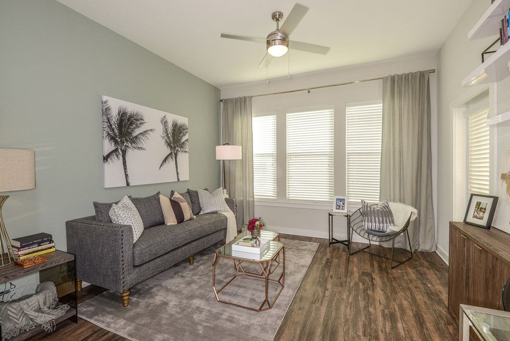 a living room with a couch and a ceiling fan  at Grady Square, Florida