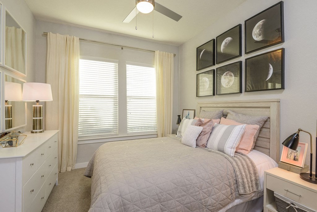 a bedroom with a bed and a ceiling fan  at Grady Square, Florida