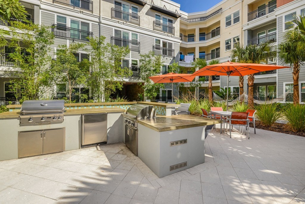 a patio with several stainless steel appliances and a building  at Grady Square, Florida, 33607
