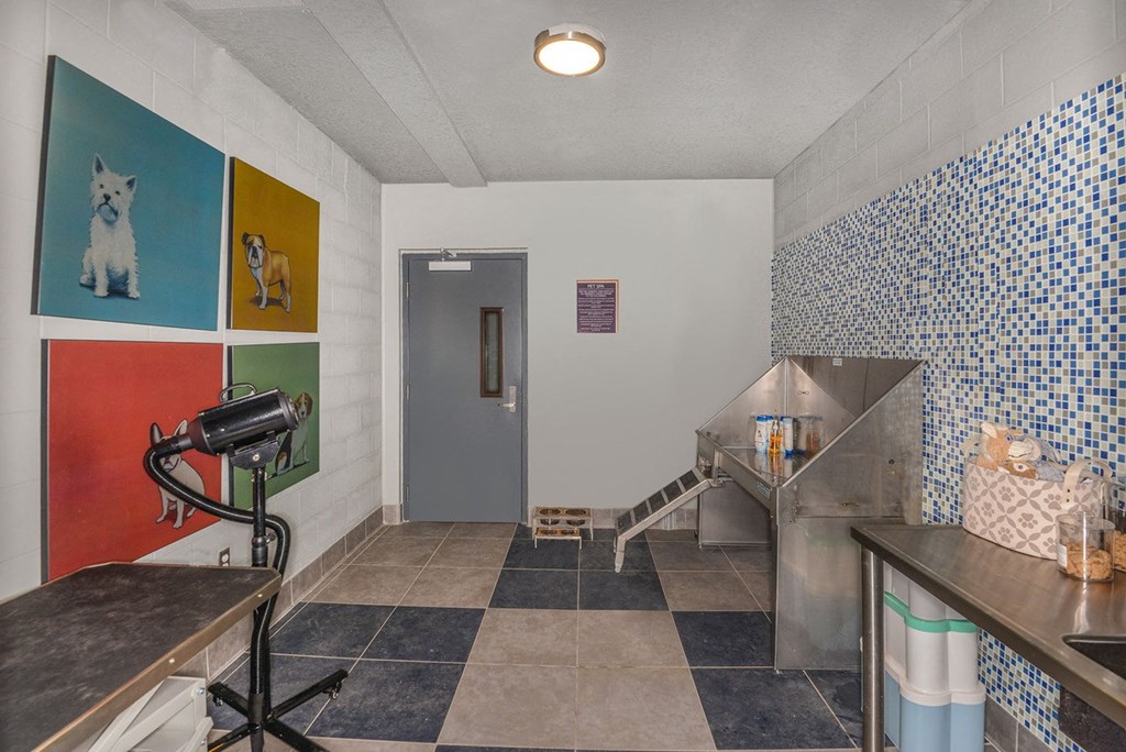 a laundry room with a washing machine and a blue door  at Grady Square, Tampa, FL