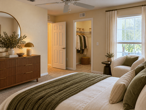 A bedroom with a large bed and a wooden dresser.