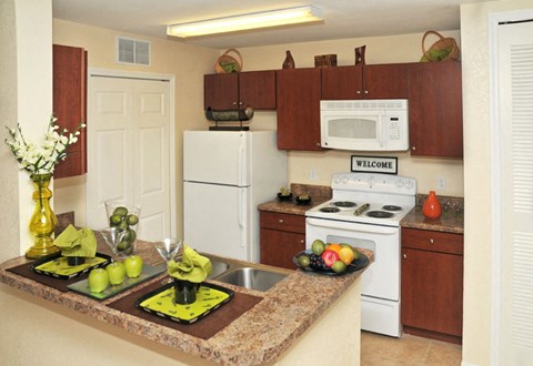 a kitchen with white appliances and a granite counter top
