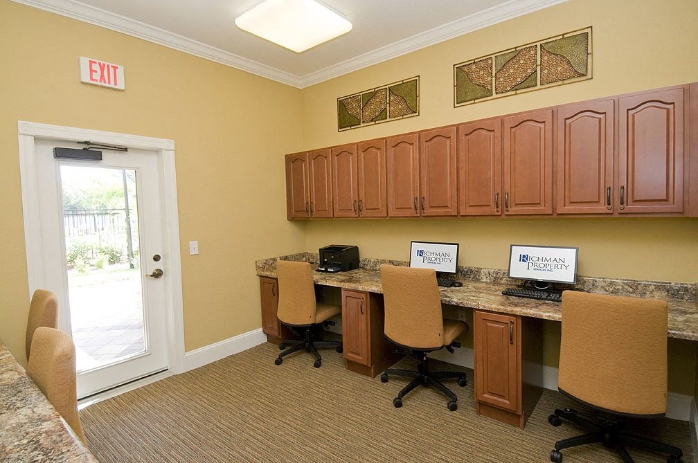 a break room with two computers and four chairs
