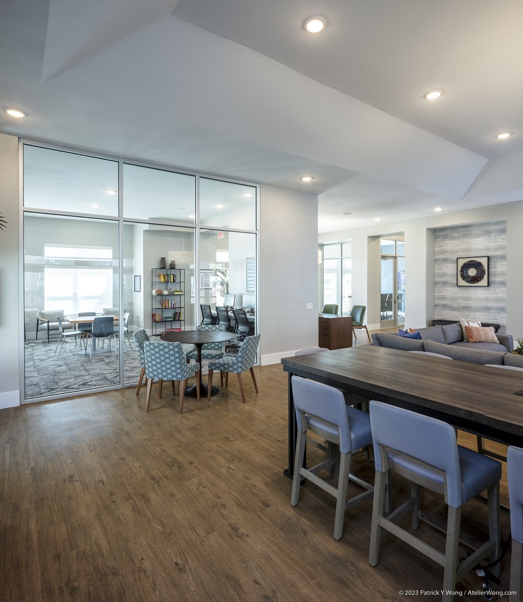 A modern dining room with a wooden table and chairs.