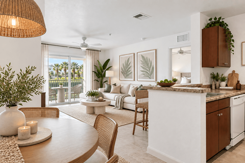 A well-lit, modern kitchen and dining area with a table set for two.