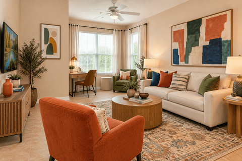 A living room with a red chair and a white couch.