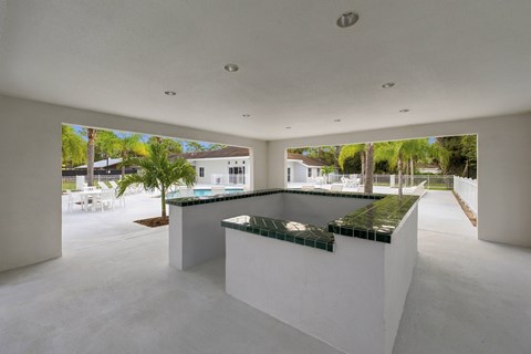 A modern house with a pool and a kitchen area.