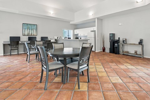 A dining room with a table and chairs.