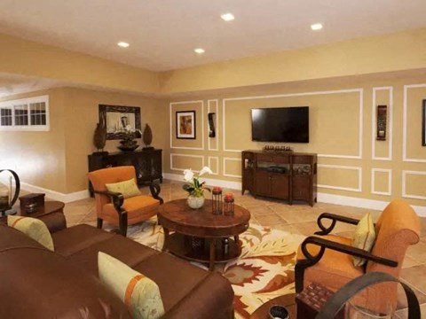 a living room with a couch and chairs and a television