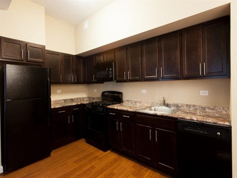a kitchen with black appliances and granite counter tops