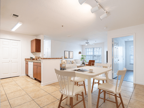 A kitchen with a table and chairs in the foreground.