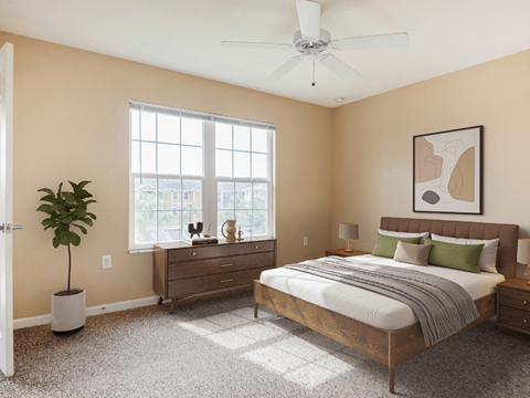 A bedroom with a bed, dresser, and ceiling fan.