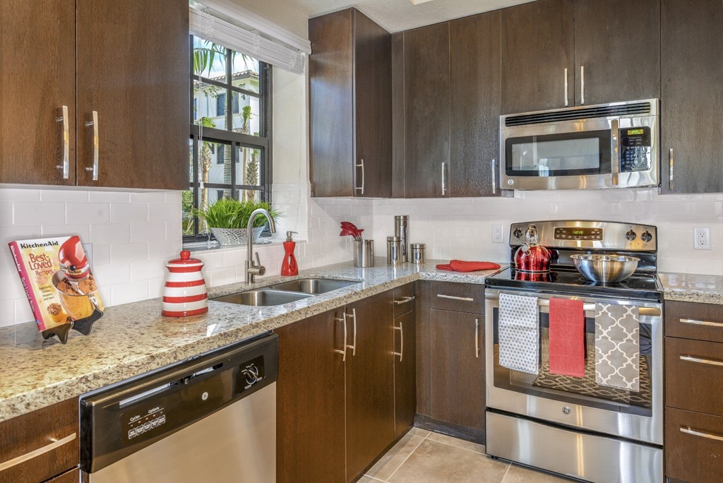 Modern kitchen with granite countertops at Palm Ranch Apartments in Davie, FL