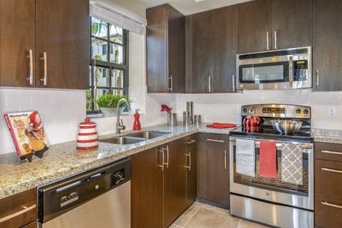a kitchen with stainless steel appliances and granite counter tops