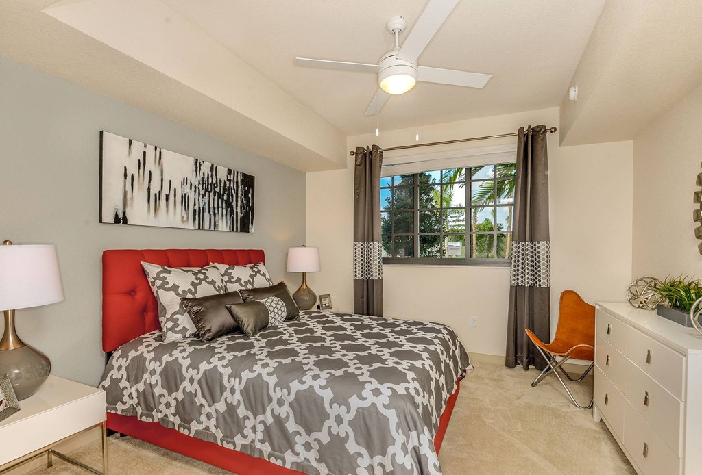 Bedroom with large window and a ceiling fan at Palm Ranch Apartments in Davie, FL