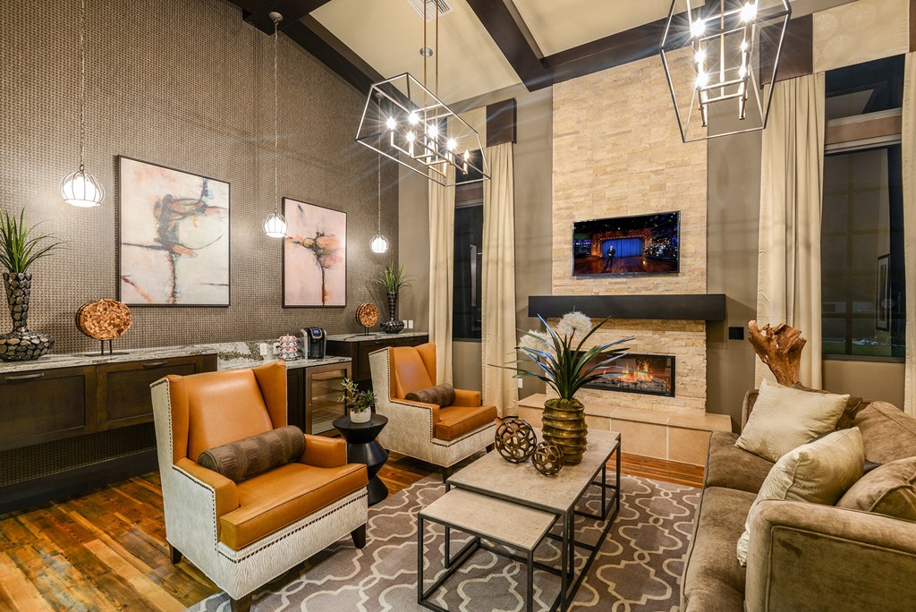 Sitting area with a fireplace in the clubhouse at Palm Ranch Apartments in Davie, FL