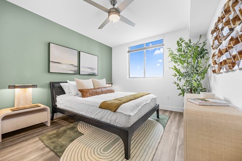 a bedroom with a bed and a ceiling fan