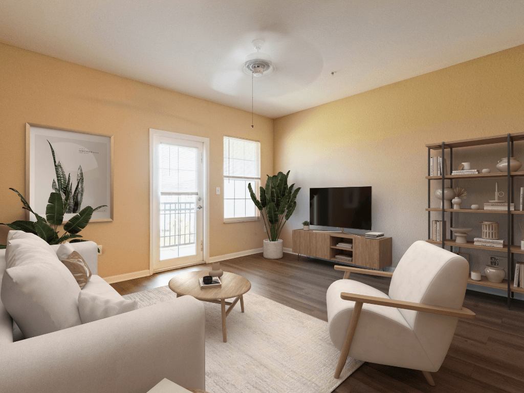 A living room with a white sofa, a wooden coffee table, a television, and a bookshelf.