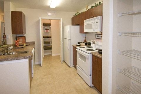 a kitchen with a stove refrigerator and a sink