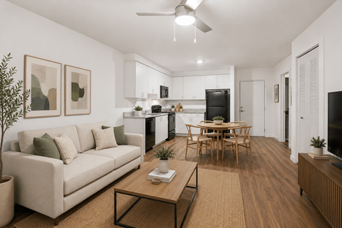 A living room with a couch, a coffee table, and a television.