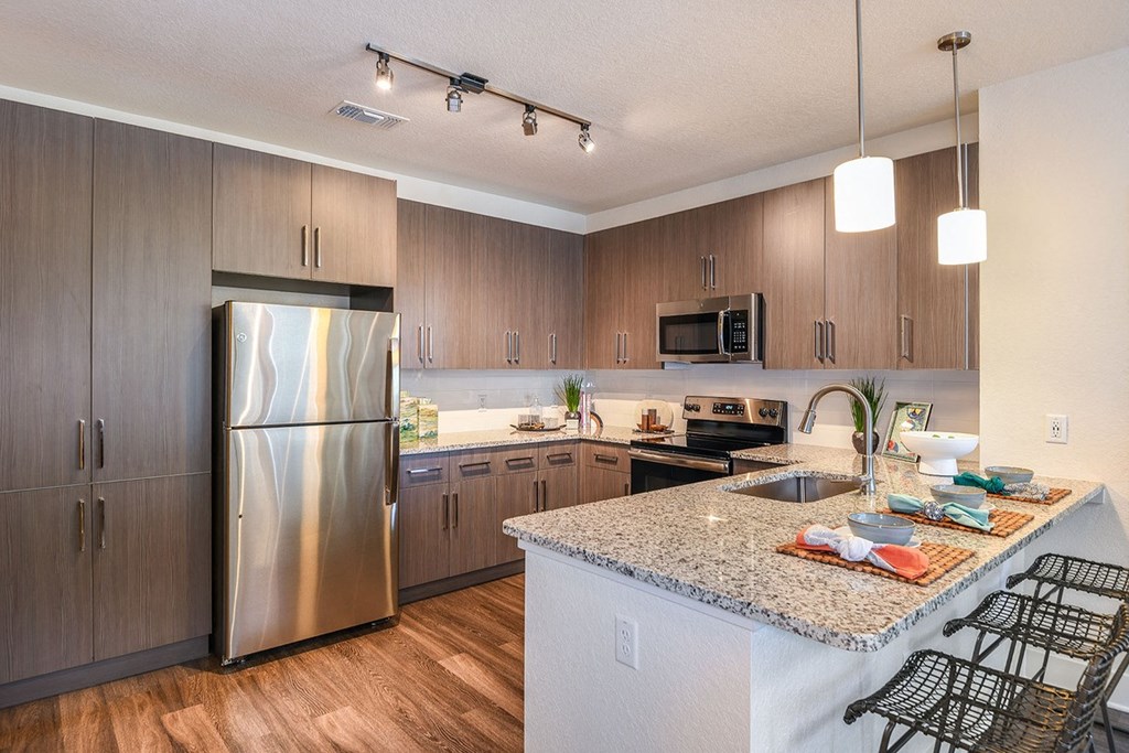 Kitchen with stainless steel appliances at The Exchange Luxury Apartments in St. Petersburg, FL