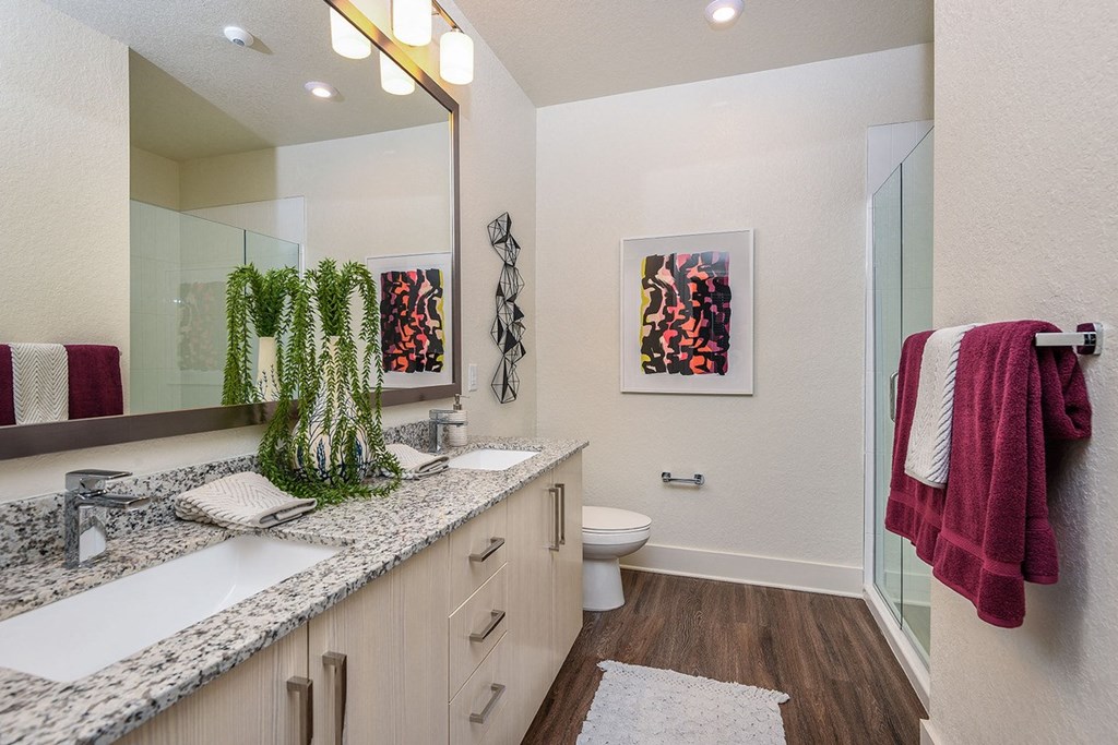 Bathroom with double vanity in select homes at The Exchange Luxury Apartments in St. Petersburg, FL