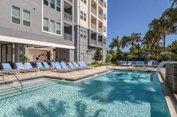 Resort-Style Swimming Pool with Waterfall at The Exchange Luxury Apartments in St. Petersburg, FL