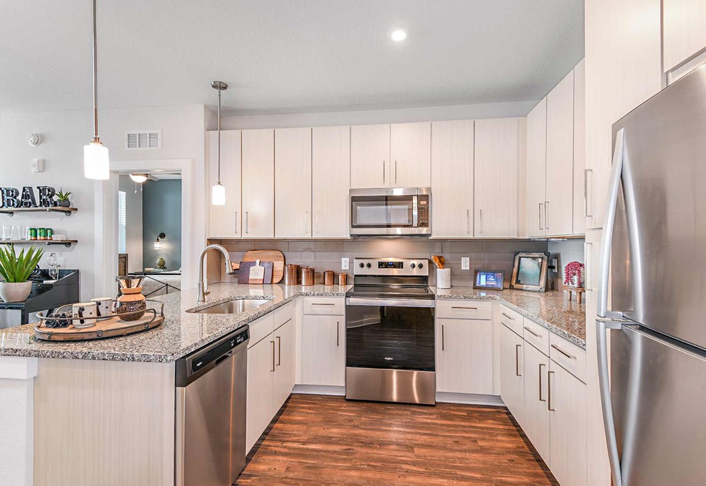 Open kitchen with upscale finishes at The Foundry Luxury Apartments in Tampa FL