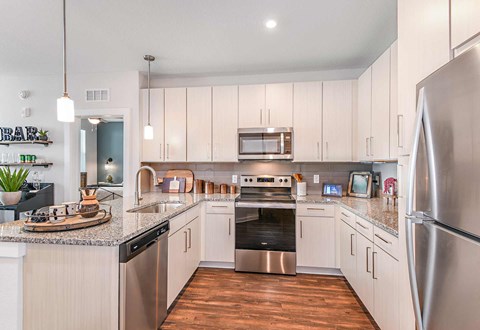 a kitchen with stainless steel appliances and white cabinets