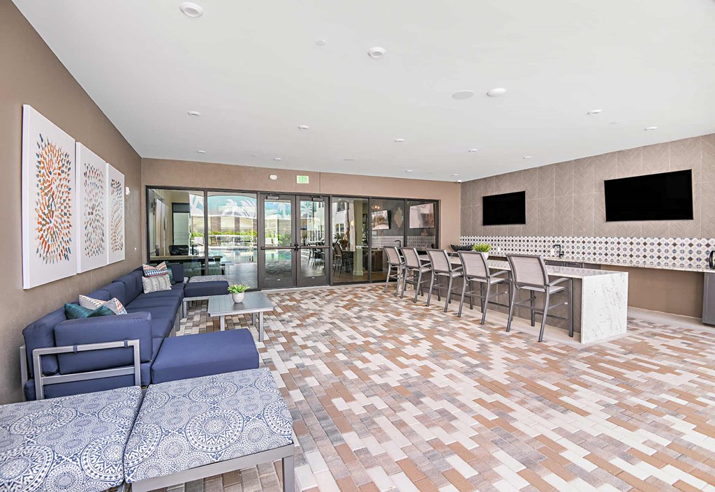 Lounge area with TVs and a bar at The Foundry Luxury Apartments in Tampa FL