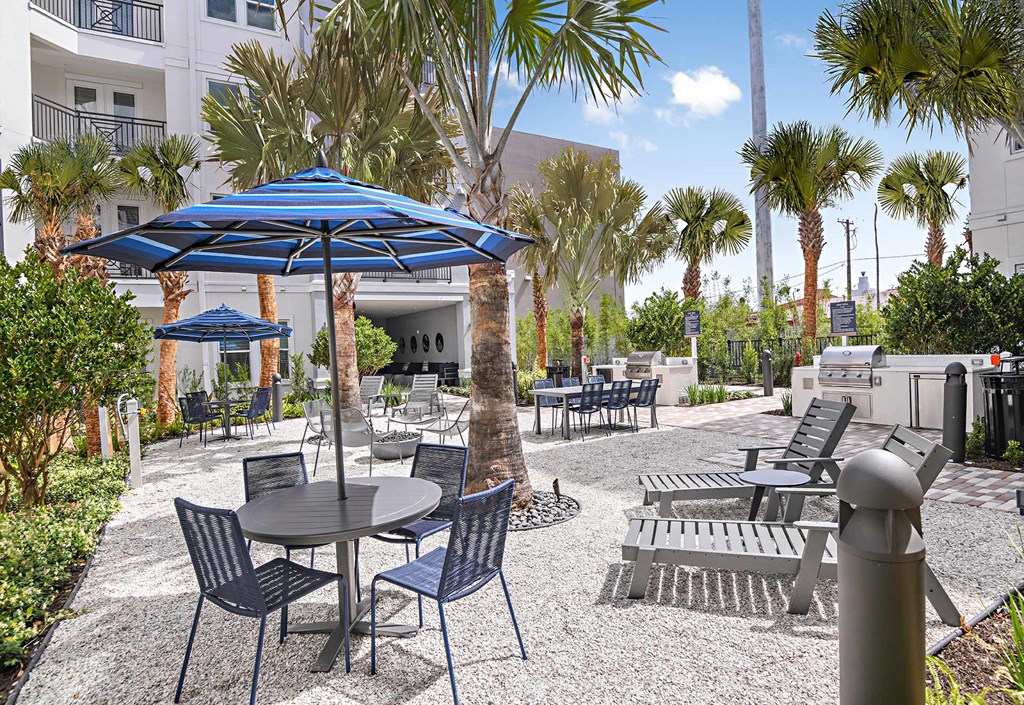 Outdoor courtyard with grills and seating at The Foundry Luxury Apartments in Tampa FL
