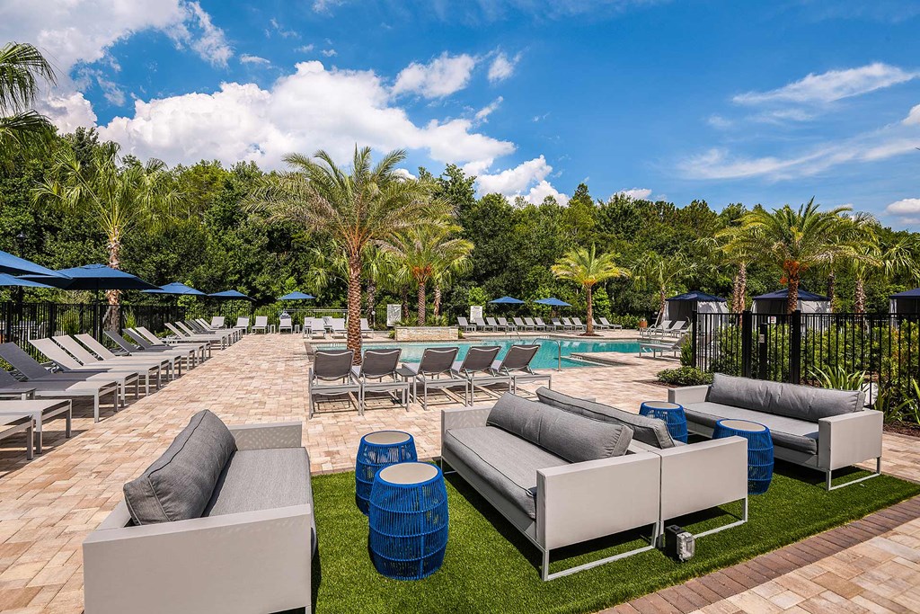 A poolside area with lounge chairs and umbrellas.